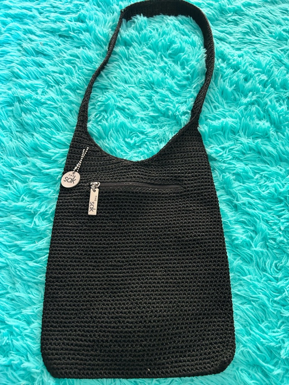 The Sak Black Crochet Hobo Bag with Branded Charm